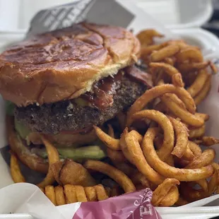 BBQ burger (bbq sauce, bacon, cheddar cheese, onion ring, avocado slices, lettuce, tomato) with curly fries