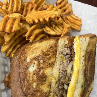 Steak Egg and Cheese melt with waffle fries.