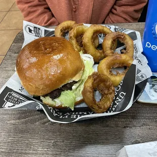 Burger and side of onion rings.