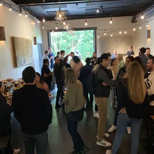 a large group of people standing in a room