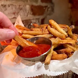 a basket of french fries with ketchup