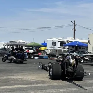 Golf cart pulling dragster to the pits!