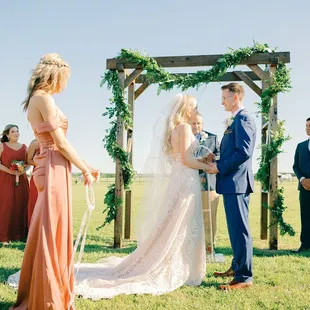 Outdoor ceremony arch and vows.
