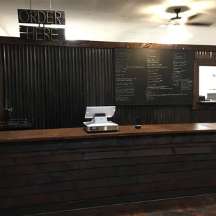 a bar with a chalkboard on the wall