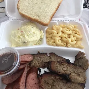 a tray of meat, macaroni, and cheese