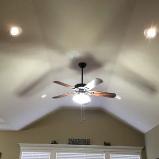 Living room vaulted ceiling updated with LED eye ball cans and updated ceiling fan with LED lighting.