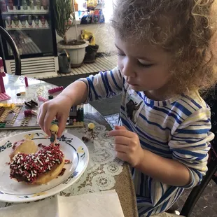 a little girl eating a donut