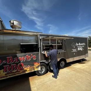 a man standing in front of a food truck