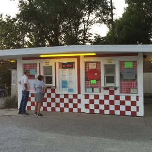 two men standing in front of a diner