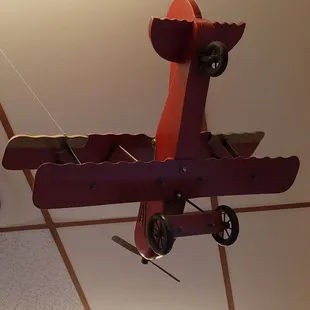 a toy airplane suspended from the ceiling