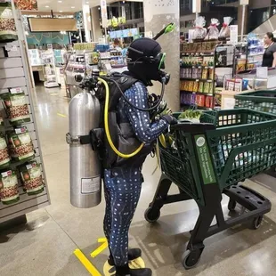 a man in a diving suit with a gas can