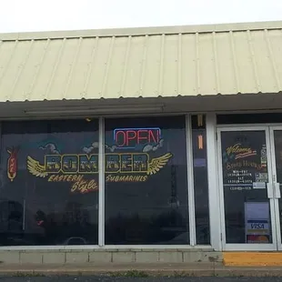 two cars parked in front of a restaurant