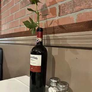 a rose in a wine bottle
