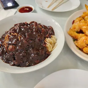 a plate of noodles and a bowl of beef