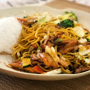 a plate of stir fried noodles and vegetables