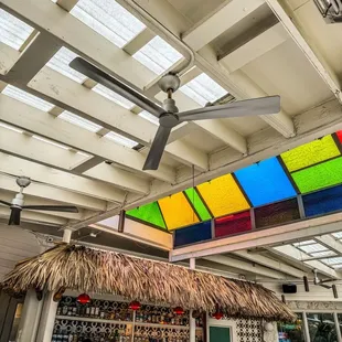 a restaurant with a colorful ceiling