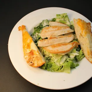 a plate of chicken and salad