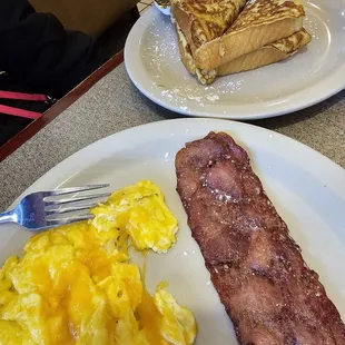French toast, scrambled eggs, and turkey bacon