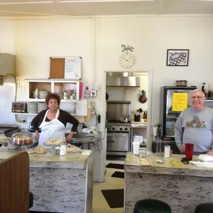 The owners behind the counter