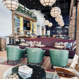 a living room with green chairs and a black coffee table