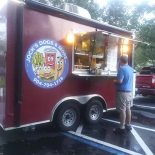 a man standing in front of a food truck