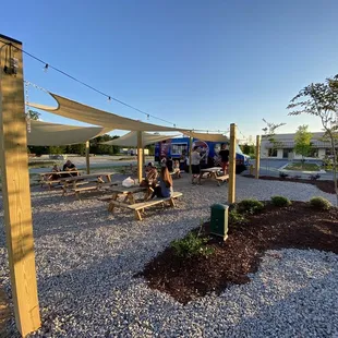 Here&apos;s a look at our exterior area! We feature six picnic tables, so you can enjoy your food truck meals comfortably during the summer!