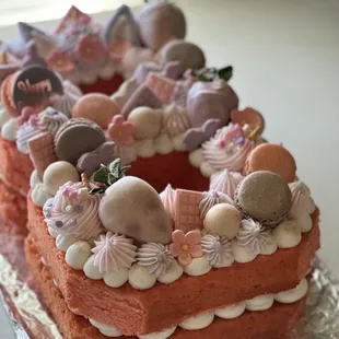 Strawberry number cake with vanilla buttercream, macarons, chocolate covered strawberries, and a variety of chocolates.
