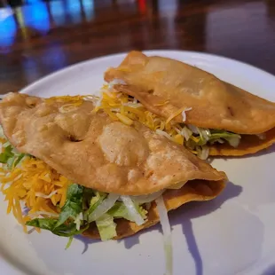 Shredded beef and chicken tacos, only $1.50 apiece on Taco Tuesday.