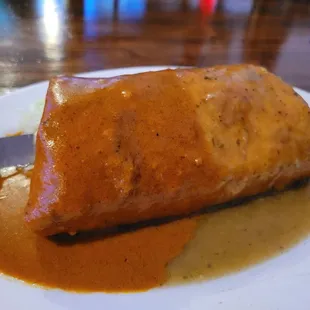 Napolitas Burrito filled with chopped cactus and pork with cheese. Two sauces complete the package.