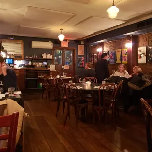 people sitting at tables in a restaurant