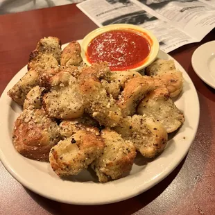 a plate of breadsticks and sauce