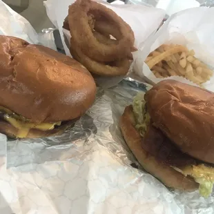 Western burger and classic American burger with onion rings and fries