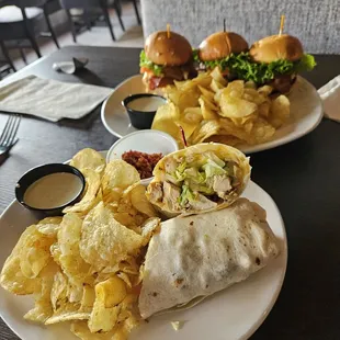 Grilled Chicken Wrap and Chicken Sliders, both served with chips.