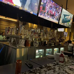 a bar with multiple televisions