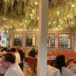 people sitting at tables in a restaurant