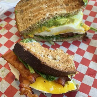 BEAST sammy: bacon, egg, piles of avocado,  and spinach toasted on wheat. I skipped the tomatoes, added cheese