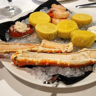 Colossal Shrimp Cocktail Shrimp poached in Aromatic Courte Bouillon with Fiery House Sauce and my - Chilled King Crab Legs Half Pound, Lemon