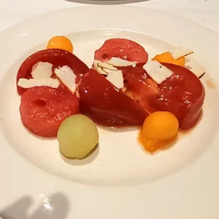 Heirloom Tomato Salad- Heirloom tomatoes with summer Melon, Toasted Ricotta, and Yuzu Vinaigrette