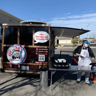 a man standing in front of a food truck