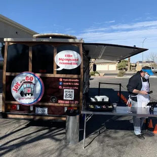 a man standing in front of a food truck