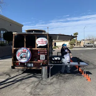 a man standing in front of a coffee cart