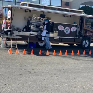 a man standing in front of a food truck