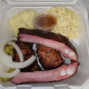 Two meat plate, with ribs and armadillo eggs and potato salad and mac and cheese.