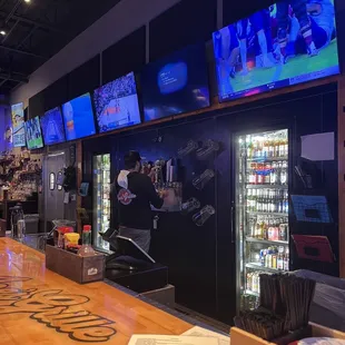 a view of the bar and televisions