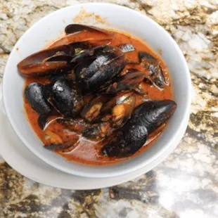 Black East Coast Mussels appetizer, and a red spicy sauce! Delicious!!