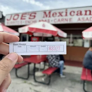 a hand holding a check