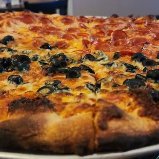 a pizza with pepperoni and olives