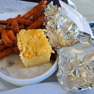 Brisket plate with sweet potato fries, potato salad and cornbread