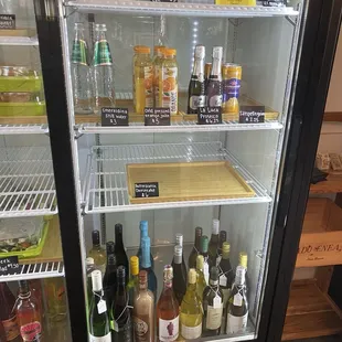 a refrigerator full of alcohol and condiments