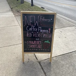 a chalkboard sign on a sidewalk